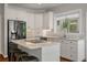 Bright kitchen features granite counters, stainless appliances, and a large central island with seating at 1339 River Otter Court, Mount Pleasant, SC 29466