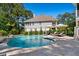 Backyard view of a stunning pool with a fountain, surrounded by a patio and lush greenery for privacy at 1339 River Otter Court, Mount Pleasant, SC 29466
