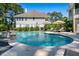 Backyard view of a stunning pool with a fountain, surrounded by a patio and lush greenery for privacy at 1339 River Otter Court, Mount Pleasant, SC 29466