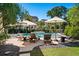 A tranquil backyard oasis featuring a sparkling pool, cozy lounge chairs, and lush landscaping at 1339 River Otter Court, Mount Pleasant, SC 29466