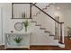 Classic staircase featuring hardwood steps and white railings with stylish decor at 1339 River Otter Court, Mount Pleasant, SC 29466
