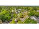 An aerial view shows well-manicured neighborhood homes nestled among lush green trees and winding streets at 134 Comiskey Park Cir, Summerville, SC 29485