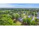 An aerial view of a charming neighborhood with tree-lined streets, well-maintained homes, and lush green surroundings at 134 Comiskey Park Cir, Summerville, SC 29485