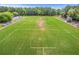 Aerial view of the football field, highlighting the goalposts, stadium seating, and well-maintained sports facility at 134 Comiskey Park Cir, Summerville, SC 29485