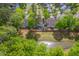 Backyard aerial view highlighting the pond and wooded surroundings of the property, adding to the home's serene atmosphere at 134 Comiskey Park Cir, Summerville, SC 29485