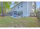 Wide shot of backyard, featuring a screened in porch and patio with seating, along a newly installed fence at 134 Comiskey Park Cir, Summerville, SC 29485