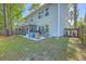 Wide shot of backyard, featuring a screened in porch and patio with seating, along a newly installed fence at 134 Comiskey Park Cir, Summerville, SC 29485