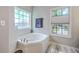 Bathroom features a large corner tub with a view from two windows offering plenty of natural light at 134 Comiskey Park Cir, Summerville, SC 29485