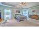 Spacious bedroom features a tray ceiling, a comfortable bed, and abundant natural light at 134 Comiskey Park Cir, Summerville, SC 29485