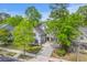 Beautiful two-story home with blue shutters, a well-manicured lawn, and a paved driveway at 134 Comiskey Park Cir, Summerville, SC 29485