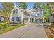 Charming two-story home with gray siding, blue shutters, landscaped yard and a welcoming front porch at 134 Comiskey Park Cir, Summerville, SC 29485