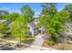Beautiful two-story home with blue shutters, a well-manicured lawn, and a paved driveway at 134 Comiskey Park Cir, Summerville, SC 29485