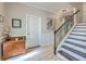 Open foyer featuring wood floors, a staircase with rod iron spindles, and decorative touches at 134 Comiskey Park Cir, Summerville, SC 29485