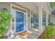 Welcoming front entrance with a blue door, sidelights, transom window, and lovely landscaping at 134 Comiskey Park Cir, Summerville, SC 29485