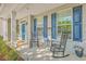 Charming front porch with rocking chairs and lovely landscaping, perfect for relaxing outdoors at 134 Comiskey Park Cir, Summerville, SC 29485