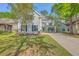 Beautiful two-story home with a well-manicured lawn, mature trees, and a welcoming front porch at 134 Comiskey Park Cir, Summerville, SC 29485