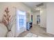 Light-filled hallway with a charming side table and an inviting view of the bathroom at 134 Comiskey Park Cir, Summerville, SC 29485