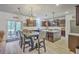 Beautiful kitchen with dark wood cabinets, a center island, stainless steel appliances, and dining table at 134 Comiskey Park Cir, Summerville, SC 29485