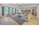 Open-concept living room with large sofa, ceiling fan, and a view to the kitchen at 134 Comiskey Park Cir, Summerville, SC 29485