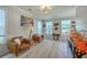 Stylish living room with wood floors, neutral walls, large windows, and comfortable seating at 134 Comiskey Park Cir, Summerville, SC 29485