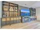 Entertainment center with shelves, cabinets, and a large television; laminate wood flooring at 134 Comiskey Park Cir, Summerville, SC 29485