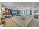 Bright living room featuring a large comfortable sofa, a ceiling fan, and an entertainment center with shelves and cabinets at 134 Comiskey Park Cir, Summerville, SC 29485