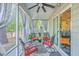 Inviting screened-in porch with ceiling fan and comfortable seating, perfect for relaxing outdoors at 134 Comiskey Park Cir, Summerville, SC 29485
