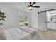 Bright bedroom features vinyl floors, barn door, and a ceiling fan at 1387 W Lenevar Dr, Charleston, SC 29407