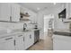 Bright kitchen with white cabinets, floating shelves, stainless appliances, and open concept design at 1387 W Lenevar Dr, Charleston, SC 29407