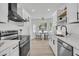 Modern kitchen features stainless appliances and flows into a bright breakfast nook with a bay window at 1387 W Lenevar Dr, Charleston, SC 29407