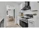 Modern kitchen with white cabinets, stainless steel appliances, and an open view to the dining room at 1387 W Lenevar Dr, Charleston, SC 29407