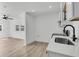 Spacious living area with an adjacent modern kitchen and hardwood floors at 1387 W Lenevar Dr, Charleston, SC 29407