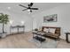 Stylish living room featuring modern ceiling fan, shiplap wall, and contemporary decor at 1387 W Lenevar Dr, Charleston, SC 29407