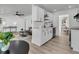 Bright, open concept living space features kitchen, dining, and living area with modern finishes at 1387 W Lenevar Dr, Charleston, SC 29407