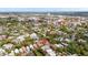 Expansive aerial view of a charming neighborhood, showcasing lush greenery and a picturesque cityscape with a river and bridge in the distance at 139 Tradd St # 2, Charleston, SC 29401