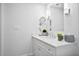 Bright bathroom with white vanity, a decorative mirror, and updated fixtures at 139 Tradd St # 2, Charleston, SC 29401