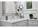 Bathroom features a white vanity with quartz countertop and a brushed nickel faucet with silver framed mirror at 139 Tradd St # 2, Charleston, SC 29401