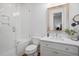 Bright bathroom featuring white tiled shower, toilet, wood floors, vanity and a framed mirror at 139 Tradd St # 2, Charleston, SC 29401