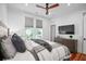 Well lit bedroom with mounted TV and two large windows at 139 Tradd St # 2, Charleston, SC 29401