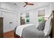 Bright bedroom featuring a ceiling fan, hardwood floors, and two windows at 139 Tradd St # 2, Charleston, SC 29401