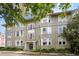 Multi-story building with a neutral color scheme, traditional architectural details, and mature trees at 139 Tradd St # 2, Charleston, SC 29401