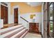 Foyer with staircase, console table, wooden door and neutral colored wall at 139 Tradd St # 2, Charleston, SC 29401