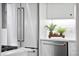 Modern kitchen with stainless steel refrigerator, dishwasher, white cabinets, quartz countertops, and stylish decor at 139 Tradd St # 2, Charleston, SC 29401