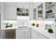 Bright kitchen features white cabinetry, subway tile backsplash, stainless steel appliances, and quartz countertops at 139 Tradd St # 2, Charleston, SC 29401