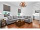 Bright and spacious living room features a large sectional sofa and hardwood floors at 139 Tradd St # 2, Charleston, SC 29401