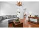 Open-concept living room with hardwood floors, access to kitchen and a comfortable gray sofa at 139 Tradd St # 2, Charleston, SC 29401