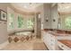 Elegant bathroom with a soaking tub, walk-in shower, and custom vanity at 14 Royal Beach Dr, Kiawah Island, SC 29455