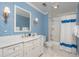 Bathroom with blue patterned wallpaper, stylish vanity, marble countertop, and shower-tub combo with curtain at 14 Royal Beach Dr, Kiawah Island, SC 29455