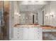 A luxurious bathroom with marble countertops, and bright lighting at 14 Royal Beach Dr, Kiawah Island, SC 29455