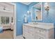 Charming bathroom featuring blue wallpaper, marble countertops, and an elegant mirror at 14 Royal Beach Dr, Kiawah Island, SC 29455
